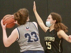 Stratford District secondary school's Trinity Marzak defends against a St. Anne's player during Wednesday's senior girls' basketball semifinal. SDSS won 33-31