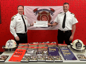 St. Marys' fire Chief Richard Anderson, left, and chief fire prevention officer Brian Leverton display firefighter training materials purchased with a donation from Enbridge Gas.