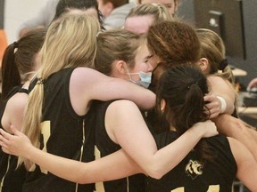 Stratford District secondary school senior girls’ basketball players celebrate a Huron-Perth double-A/triple-A title after knocking off St. Mike’s Wednesday at SDSS.