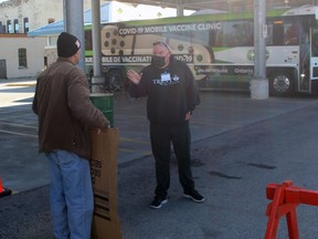 GO-VAXX mobile immunization clinic spokesperson Bill Gaunt, right, and anti-vaccine protester Sean Murphy argue outside the pop-up clinic on Monday November 1, 2021 in Petrolia, Ont. Terry Bridge/Sarnia Observer/Postmedia Network