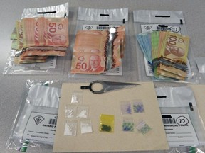 Three Walpole Island First Nation residents in their 30s are facing drug-trafficking charges after police seized drugs and cash from a Tecumseh Road home, Lambton OPP say. (Lambton OPP/Twitter)