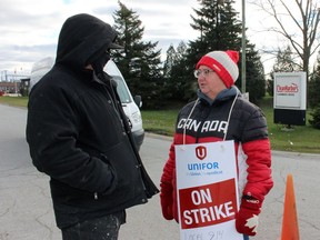 Korry Patterson, chief steward of the Unifor Local 914 bargaining unit, left, and member Stacey Nethercott stand at the entrance to Clean Harbors on Monday Nov. 22, in St. Clair Township. The union went on strike as of midnight Monday. Terry Bridge/Sarnia Observer/Postmedia Network