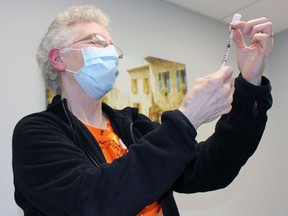 Nancy Spragg, a registered practical nurse, draws a syringe of a COVID-19 vaccine at Dr. Cassandra Taylor's Sarnia office. Terry Bridge/Sarnia Observer/Postmedia Network