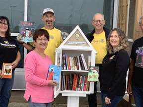 The Rotary Club of Norfolk Sunrise (RCNS) recently installed four little lending libraries in Norfolk. One of the lending libraries has been placed at Riversyde 83 in downtown Simcoe. On hand for the opening were, front from left, Mary Mercato of RCNS, Louise Schebesch, president of RCNS, and Eric Haverkamp of Church Out Serving (Riversyde 83); back row, Virginia Lucas of Church Out Serving (Riversyde 83), along with Rotarians Jim Simpson and Ross Gowan.