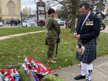 Waterford native Ian Angus prepares to place a poppy at the town's cenotaph following Thursday's Remembrance Day service. Angus served in the U.S. Marines. KIM NOVAK Simcoe Reformer