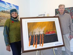 Stephanie Doveton, left, board member of Northern Artists Gallery, and local artist Bill Whittaker stand next to his artwork at a Northern Artists Gallery pop-up at Plaza 69 in Sudbury, Ont. For more information, or to purchase artwork, visit northernartistsgallery.ca. John Lappa/Sudbury Star/Postmedia Network