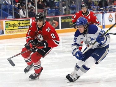 Ethan Larmand, right, of the Sudbury Wolves, and Landon Cato, of the Niagara IceDogs, chase down the puck during OHL action at the Sudbury Community Arena in Sudbury, Ont. on Friday November 5, 2021. John Lappa/Sudbury Star/Postmedia Network