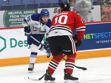 Ethan Larmand, left, of the Sudbury Wolves, attempts to fire the puck past Mason Howard, of the Niagara IceDogs, during OHL action at the Sudbury Community Arena in Sudbury, Ont. on Friday November 5, 2021. John Lappa/Sudbury Star/Postmedia Network
