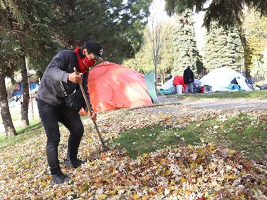 Jordan helps to clean up Memorial Park in Sudbury, Ont. on Wednesday November 10, 2021. Jordan has lived at the park encampment, but now lives in a tent at a different location in the city. John Lappa/Sudbury Star/Postmedia Network