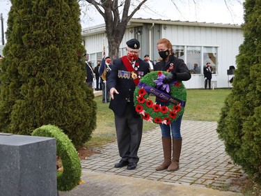 Sergeant-at-Arms Fred Medynski escorts Silver Cross Mother Wendy Miller as she prepares to lay a wreath at a Remembrance Day service at Branch 76 of the Royal Canadian Legion in Sudbury, Ont. on Thursday November 11, 2021. John Lappa/Sudbury Star/Postmedia Network