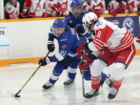 Greater Sudbury Cubs forward Pierson Sobush (91) drives toward the Elliot Lake Red Wings goal while teammate Cameron Walker (8) follows and Elliot Lake defenceman Teegan Dumont (12) defends during first-period NOJHL action at Gerry McCrory Countryside Sports Complex in Sudbury, Ontario on Thursday, November 11, 2021. Visit www.thesudburystar.com for a story on Thursday's game. Ben Leeson/The Sudbury Star/Postmedia Network