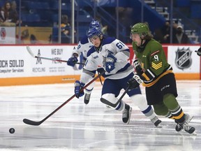 Chase Stillman, left, of the Sudbury Wolves, and Josh Currie, of the North Bay Battalion, chase after the puck during OHL action at the Sudbury Community Arena in Sudbury, Ont. on Friday November 12, 2021. John Lappa/Sudbury Star/Postmedia Network