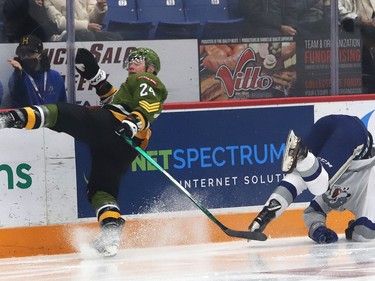 Nick DeGrazia, right, of the Sudbury Wolves, and Ty Nelson, of the North Bay Battalion, collide during OHL action at the Sudbury Community Arena in Sudbury, Ont. on Friday November 12, 2021. John Lappa/Sudbury Star/Postmedia Network