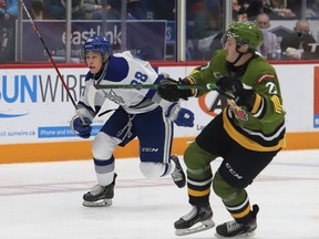 David Goyette, left, of the Sudbury Wolves, and Mitchell Russell, of the North Bay Battalion, chase after the puck during OHL action at the Sudbury Community Arena in Sudbury, Ont. on Friday November 12, 2021. John Lappa/Sudbury Star/Postmedia Network