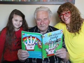 Author and educator Linda LaRouche shows off her book, entitled The Finger Family Adventures, with the help of her granddaughter, Kiandra Guenette, 7, and her dad, Eddo Nardi, in Sudbury, Ont. LaRouche wrote and illustrated the book. John Lappa/Sudbury Star/Postmedia Network