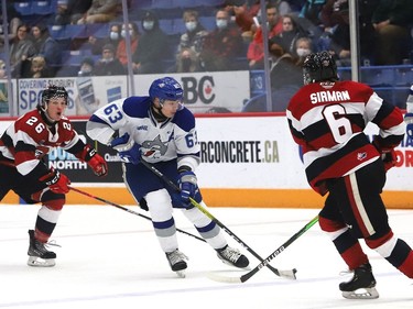 Liam Ross, middle, of the Sudbury Wolves, attempts to skate between Alec Belanger, left, and Thomas Sirman, of the Ottawa 67's, during OHL action at the Sudbury Community Arena in Sudbury, Ont. on Friday November 19, 2021. John Lappa/Sudbury Star/Postmedia Network
