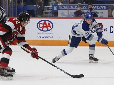 Evan Konyen, right, of the Sudbury Wolves, attempts to skate past Matthew Mayich, of the Ottawa 67's, during OHL action at the Sudbury Community Arena in Sudbury, Ont. on Friday November 19, 2021. John Lappa/Sudbury Star/Postmedia Network