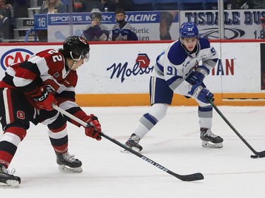 Evan Konyen, right, of the Sudbury Wolves, attempts to skate past Matthew Mayich, of the Ottawa 67's, during OHL action at the Sudbury Community Arena in Sudbury, Ont. on Friday November 19, 2021. John Lappa/Sudbury Star/Postmedia Network