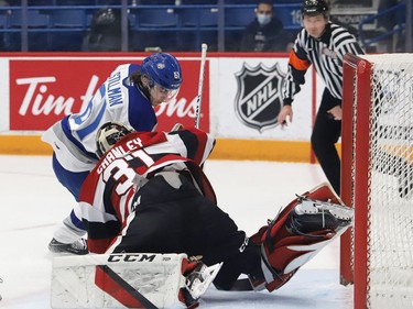 Chase Stillman, of the Sudbury Wolves, attempts to poke the puck past goalie Will Cranley, of the Ottawa 67's, during OHL action at the Sudbury Community Arena in Sudbury, Ont. on Friday November 19, 2021. John Lappa/Sudbury Star/Postmedia Network