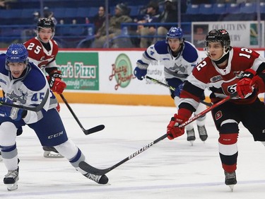Ethan Larmand, left, of the Sudbury Wolves, and Anthony Costantini, of the Ottawa 67's, chase after the puck during OHL action at the Sudbury Community Arena in Sudbury, Ont. on Friday November 19, 2021. John Lappa/Sudbury Star/Postmedia Network
