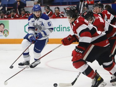 Chase Stillman, left, of the Sudbury Wolves, attempts to steal the puck during OHL action against the Ottawa 67's at the Sudbury Community Arena in Sudbury, Ont. on Friday November 19, 2021. John Lappa/Sudbury Star/Postmedia Network