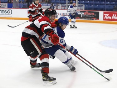 Chase Stillman, right, of the Sudbury Wolves, and Teddy Sawyer, of the Ottawa 67's, battle for the puck during OHL action at the Sudbury Community Arena in Sudbury, Ont. on Friday November 19, 2021. John Lappa/Sudbury Star/Postmedia Network