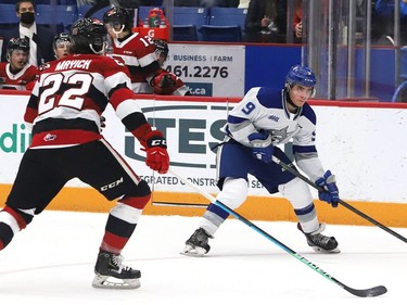 Alex Assadourian, right, of the Sudbury Wolves, attempts to skate past Matthew Mayich, of the Ottawa 67's, during OHL action at the Sudbury Community Arena in Sudbury, Ont. on Friday November 19, 2021. John Lappa/Sudbury Star/Postmedia Network