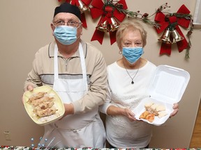 Paul Halushenski and Emily Lukie show some of the food items that will be available at a curbside, pickup only, Christmas luncheon at St. Mary's Ukrainian Catholic Church in Sudbury, Ont. on December 2, 2021, from 11 a.m. to 1 p.m. Meals are $15 and include four pyrohy, two cabbage rolls, a pork meat stick and borscht soup. Other food items available include a dozen pyrohy, or a dozen cabbage rolls at $10 each, a jar of borscht for $10 and pork meat sticks $4 each. Preorders will be taken until November 29, or until sold out. To place an order, call 705-675-8244, or 705-675-1581. Orders over $100 can be delivered within the city. As well, December 13, 2021, is the last day to order Christmas orders. John Lappa/Sudbury Star/Postmedia Network
