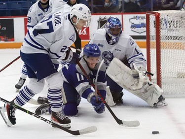Landon McCallum, middle, of the Sudbury Wolves, scrambles for the puck during OHL action against the Mississauga Steelheads at the Sudbury Community Arena in Sudbury, Ont. on Friday November 26, 2021. John Lappa/Sudbury Star/Postmedia Network