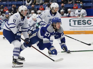 Quentin Musty, right, of the Sudbury Wolves, is tripped up by Kai Schwindt, of the Mississauga Steelheads, during OHL action at the Sudbury Community Arena in Sudbury, Ont. on Friday November 26, 2021. John Lappa/Sudbury Star/Postmedia Network