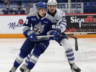 David Goyette, left, of the Sudbury Wolves, and Ethan Del Mastro, of the Mississauga Steelheads, battle for position during OHL action at the Sudbury Community Arena in Sudbury, Ont. on Friday November 26, 2021. John Lappa/Sudbury Star/Postmedia Network