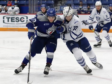 Kocha Delic, left, of the Sudbury Wolves, and Ethan Del Mastro, of the Mississauga Steelheads, battle for the puck during OHL action at the Sudbury Community Arena in Sudbury, Ont. on Friday November 26, 2021. John Lappa/Sudbury Star/Postmedia Network