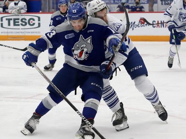 Kocha Delic, left, of the Sudbury Wolves, and Ethan Del Mastro, of the Mississauga Steelheads, battle for the puck during OHL action at the Sudbury Community Arena in Sudbury, Ont. on Friday November 26, 2021. John Lappa/Sudbury Star/Postmedia Network