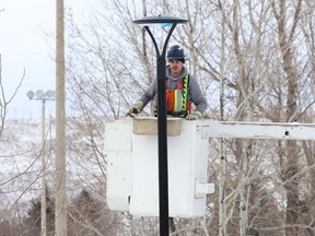 Light poles are being installed at the Delki Dozzi track in Sudbury, Ont. on Monday November 29, 2021. John Lappa/Sudbury Star/Postmedia Network