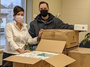 Lisa Long and Adam Killah take delivery of 6,000 reusable masks sent to the Samaritan Centre. Supplied