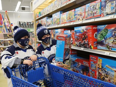 Dallyn Lalonde, 9, left, and Cole Ginson, 9, of the U10 AA Timberwolves, shop for toys in support of Our Children, Our Future's annual Tree of Dreams Toy Drive at Toys R Us in Sudbury, Ont. on Tuesday November 30, 2021. Victim Services sponsored the event in partnership with the Sudbury Minor Hockey Association's U9 Nickel Kings and the U10 AA Timberwolves. The players selected names from the Tree of Dreams and then selected toys for the children. John Lappa/Sudbury Star/Postmedia Network
