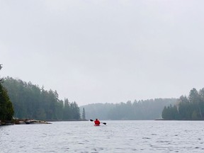 After facing a stiff headwind for nearly 8 km, Rylan takes a break to enjoy the fog while paddling back to the Jeep following an adventure on Kasakawawia Lake, north of Cartier.