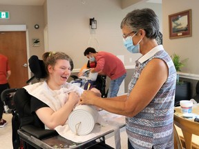 Mary Weerdenburg (right), a volunteer with the Hands On Art program, assists Standing Oaks resident Avery make some Halloween-themed art on Oct. 29.Carl Hnatyshyn/Sarnia This Week