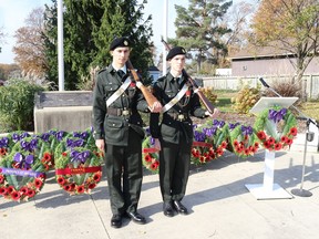 Cadets Warrant Officer Spencer Sloan (left) and Sgt. Matthew Walker (right) stand in front of wreaths laid at the base of Corunna's clock tower following Remembrance Day ceremonies on Nov. 11. Carl Hnatyshyn/Sarnia This Week
