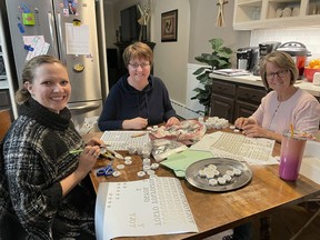 Watford Catholic Women's League executive members (from left to right) Ginny Hogervorst, Elly McAllister and Betty Thuss work on making Christmas-themed fridge magnets, part of the group's new holiday fundraiser. Handout/Sarnia This Week