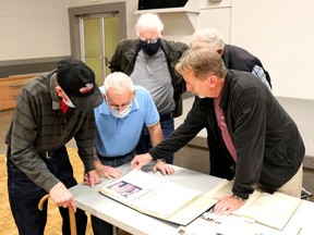 Members of the Plympton-Wyoming Historical Society look at photographs of Wyoming collected by Robert Dunsworth following his Nov. 17 presentation. Carl Hnatyshyn/Sarnia This Week