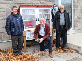 Little Free Pantry and Little Free Library volunteers stand beside their resource following a dedication ceremony in front of First Christian Reformed Church of Sarnia on Nov. 21. From left are Cupboard builder Rick Bissonnette, patio installer John DeGroot, 'all around helper' Pete Weening and project co-ordinator Linda Weening. Carl Hnatyshyn/Sarnia This Week