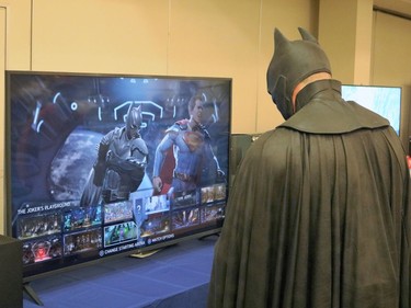 Batman tries his hand playing as his namesake while testing a video game during the Timmins Mini Con held Saturday,

ANDREW AUTIO/The Daily Press