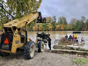 The Tillsonburg Kinsmen Club Fountaineers lift out the fountain from Lake Lisgar Saturday morning. (Submitted)