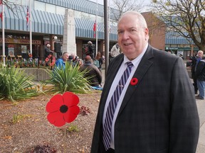 Tillsonburg Lions Club member Dave Beres stands next to a Lions Club lawn poppy near the Tillsonburg cenotaph on Remembrance Day. The Lions sold 3,000 poppies, raising more than $12,000 in their first lawn poppy campaign for Canadian veterans. (Chris Abbott/Norfolk and Tillsonburg News)