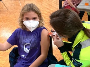 Grace Harris, 8, receives her first dose of COVID-19 vaccine at the Tillsonburg Lions Den clinic on Nov. 24. (Submitted)