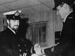 CAPT. D.R. DRAVES, vice-principal of Ferguson Public School, receives the Air Transport Command badge from Chief Petty Officer Bob McCullagh who is with the regular force as assistant area officer at headquarters in Downsview.