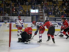 Mack Guzda smothers the puck with the Attack on the penalty kill and Declan McDonnell lurking in front as Owen Sound plays the Kitchener Rangers inside the Kitchener Memorial Auditorium Friday, Nov. 12, 2021. Greg Cowan/The Sun Times