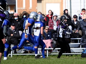 Wolves running back Austin Waite takes a quick peek behind him while he turns on the burners and heads downfield for his second of three scores on the day as the OSDSS Wolves host the Saugeen Royals in a Bluewater Athletic Association senior boys football semifinal Friday afternoon in Owen Sound. Greg Cowan/The Sun Times