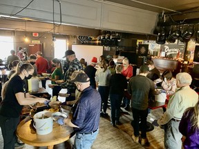 A small army of 124 volunteers helped prepare and deliver a record 1,134 free heat-and-serve turkey dinners prior to Christmas in Saugeen First Nation and Saugeen Shores. The Queen’s Bar & Grill was transformed into a socially-distanced and masked prep area in the days leading up to the Dec. 23 and 24 deliveries. [Supplied]